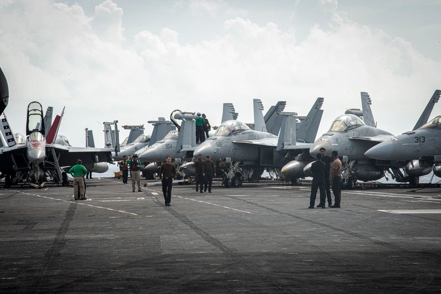 U.S. Navy sailors working on an aircraft carrier flight deck
